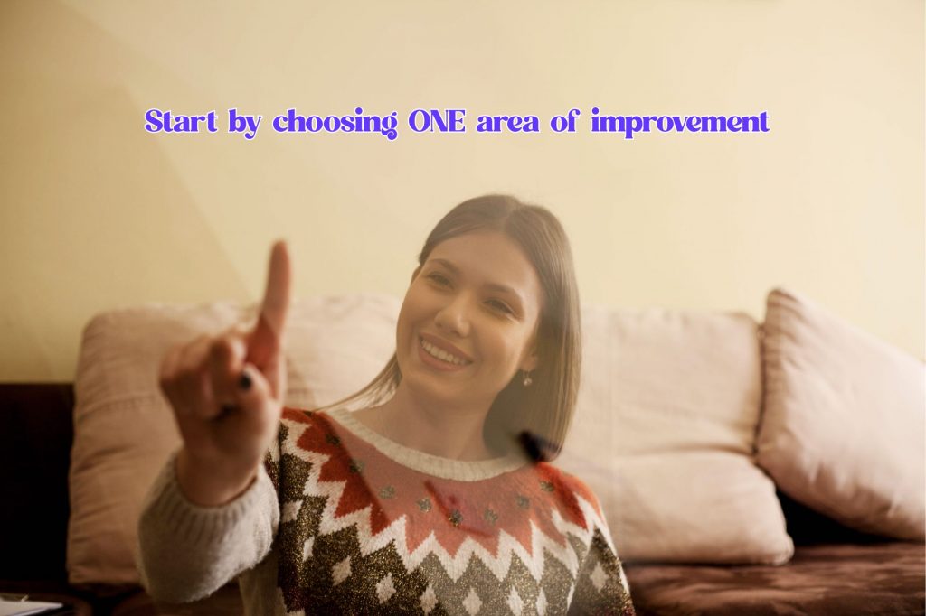 woman is holding her finger up and a text overlay reads "start by choosing ONE area of improvement" 
