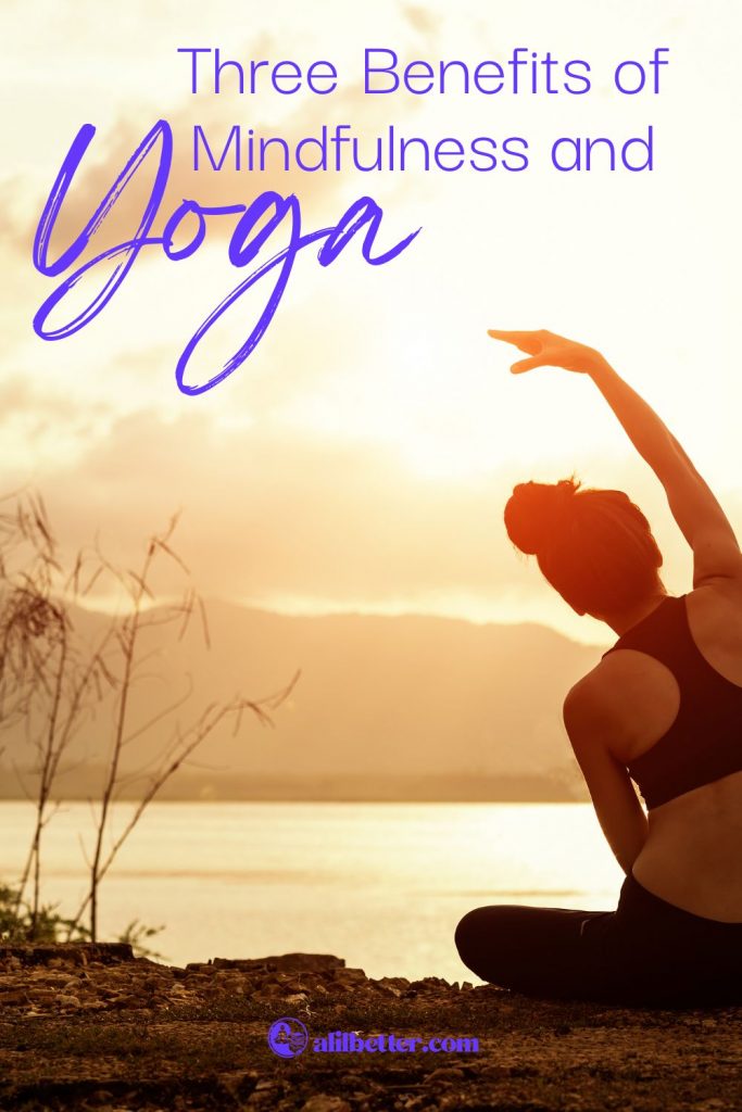 A woman sits in front of water with bamboo plants doing a side stretch with text overlay that reads "three benefits of mindfulness and yoga"
